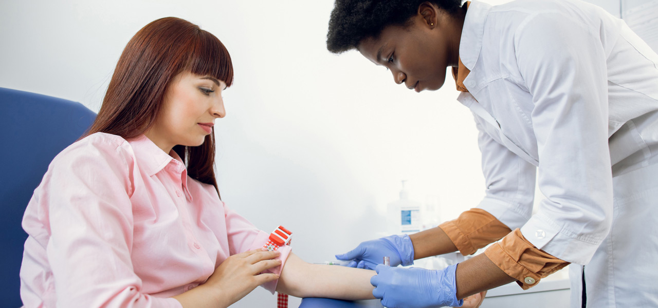 Nurse-preparing-patient’s-arm-for-injection-and-blood-draw